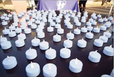  ?? File photo ?? Flameless candles flicker during a candleligh­t vigil for victims of domestic violence.