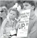  ?? Associated Press ?? ■ Chase Crawford, a Southern Baptist Convention messenger from Arkansas, and his 2-year-old daughter Chloe Jean Crawford listen to speakers during a rally protesting the Southern Baptist Convention’s treatment of women on Tuesday outside the...