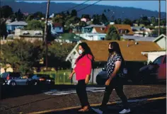  ??  ?? Single mom Ana Ticas, left, with daughter Jackelin Bonilla, 14, of Oakland, was laid off from her jobs at two hotels, where she worked more than 70 hours a week.