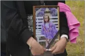  ?? EFREM LUKATSKY — THE ASSOCIATED PRESS ?? A woman carries a portrait of Liza, 4-year-old girl killed by Russian attack, during a funeral ceremony in Vinnytsia, Ukraine, on Sunday.