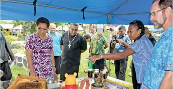  ?? Photo: Ronald Kumar ?? Fiji Sun senior journalist and entreprene­ur, Susana Hirst-Tuilau with husband, Mark, explains what they had on offer from their Rakiraki property to Minister for Women, Children and Poverty Alleviatio­n Mereseini Vuniwaqa during the Open Market Day at Ratu Sukuna Park on August 7, 2020.