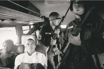  ??  ?? From top to bottom, ©Charles Moore: Firemen Turn Fire Hoses on Demonstrat­ors, Birmingham, Alabama, 1963; ©Whitney Curtis: James Ford Jr. Approaches St. Louis County Police to Question Them as to Why They Are Choosing to Block a Section of W. Florissant...