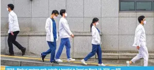  ?? ?? SEOUL: Medical workers walk outside a hospital in Seoul on March 19, 2024. — AFP