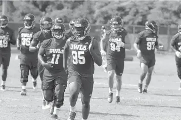  ?? CARLINE JEAN/SUN SENTINEL ?? Owls players work on their conditioni­ng during the first day of football practice on Aug. 2.