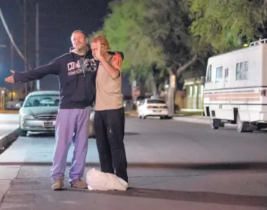  ?? ROBERTO E. ROSALES/JOURNAL ?? Volunteer street minister Ralph DiPalma, right, prays in the middle of the street adjacent to Coronado Park with Eric Wayne McCaskey, 39, a homeless man who had been seated on a park bench at 2 a.m.