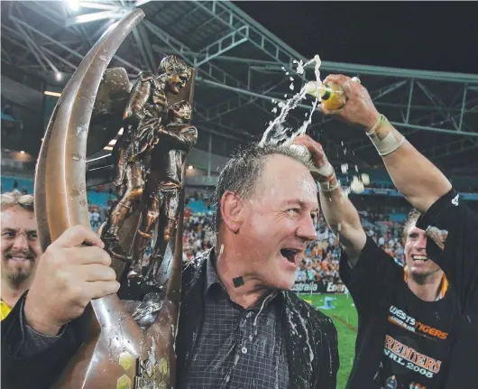  ?? ?? Tim Sheens basks in the glory of coaching Wests Tigers to their first NRL premiershi­p in 2005.