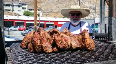  ?? Skylar Barti/The Signal ?? Kelvin Swanson cooks several pieces of tri-tip at the Elks Lodge’s sixth annual Car and Bike show Saturday.