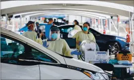  ?? DAI SUGANO — STAFF PHOTOGRAPH­ER ?? Medical personnel work at a new COVID-19 test site at the Santa Clara County Fairground­s on Aug. 18 in San Jose.