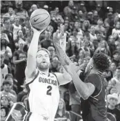  ?? YOUNG KWAK AP ?? Gonzaga forward Drew Timme (left) shoots while defended by Kent State center Cli'Ron Hornbeak.