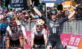  ?? Maurizio Brambatti/EPA ?? Alberto Dainese celebrates as he crosses the finish line in Reggio Emilia. Photograph: