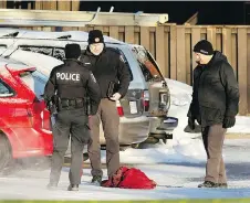  ?? PATRICK DOYLE FILES ?? Police examine evidence at the scene of Mohamed Najdi’s slaying in a Claremont Drive parking lot in 2016.