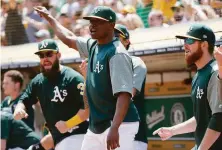  ?? Santiago Mejia / The Chronicle 2018 ?? Right-hander Jharel Cotton (center, shown in 2018) pitched for the A’s in 2016 and ’17 before elbow surgery stalled his career.