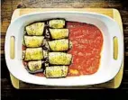  ?? ?? Spread the reserved jarred pasta in a casserole dish. Add the eggplant rolls, seam-side down.