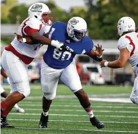  ?? Eric Christian Smith ?? West defensive tackle Jeremiah Green, center, takes on a pair of East All-Stars trying to block him Saturday night in the Bayou Bowl at Stallworth Stadium.