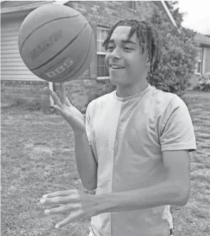  ?? KEVIN WHITLOCK/MASSILLON INDEPENDEN­T ?? Armonnie Hawkins, 14, shows off some basketball skills at his Canton Township home. Armonnie was born with a heart murmur but has since been diagnosed with a heart disease he didn’t know he had until he got a physical for sports.