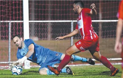  ?? SAVED: NQ United goalkeeper Daniel Wilesmith blocks a shot from Olympic player Shelford Davis. ??