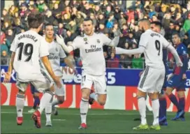  ?? AP ?? Gareth Bale (centre) celebrates the all-important goal with Real Madrid teammates on Sunday.