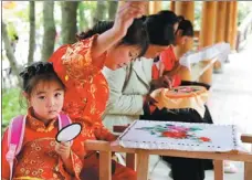  ?? PHOTOS PROVIDED TO CHINA DAILY ?? Women in Baoji village of Xihe county, Gansu province, embroider in their spare time to cover some family expenses.