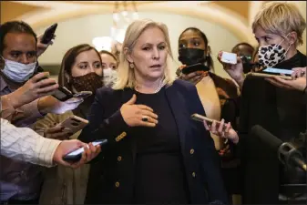  ?? Samuel Corum / Getty Images ?? Sen. Kirsten Gillibrand, D-N.Y., is surrounded by reporters as she heads to the floor of the Senate following the Democrats Policy Luncheon at the U.S. Capitol building on Tuesday in Washington, D.C. Democrats continue to negotiate within their party as they try to get the major parts of President Joe Biden's legislativ­e agenda through Congress.