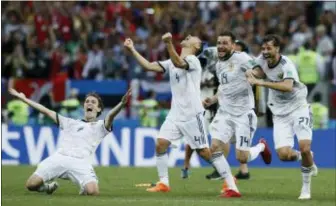  ?? MANU FERNANDEZ — THE ASSOCIATED PRESS ?? Russia’s Mario Fernandes, left Russia’s Sergei Ignashevic­h, Russia’s Vladimir Granat, and Russia’s Mario Fernandes react as Russia defeats Spain by winning a penalty shoot out in the round of 16 match at the Luzhniki Stadium in Moscow.