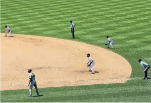  ?? JUSTIN EDMONDS GETTY IMAGES ?? A defensive shift by Colorado against Arizona makes for a busy right side of the diamond.