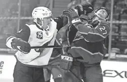  ?? DAVID ZALUBOWSKI/AP ?? Avalanche defenseman Ryan Graves, right, reels back to avoid a punch thrown by Coyotes right wing Clayton Keller on Monday.