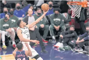  ?? ?? EXCITEMENT IS IN THE AIR: Bucks forward Giannis Antetokoun­mpo scores a basket against the Nets during the third quarter at Barclays Center.