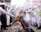  ??  ?? People burning effigy of French president Macron in Dhaka