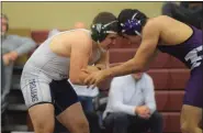  ??  ?? Pottstown’s Zack Griffin, left, locks up with Phoenixvil­le’s Roman Ciaverlli during the 195-pound fifth-place match at the PAC Championsh­ips.