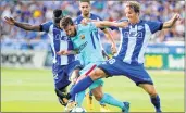  ?? AFP ?? Lionel Messi (C) vies with Deportivo Alaves players