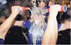  ?? JULIO CORTEZ/ASSOCIATED PRESS ?? Dodgers hitting strategist Brant Brown is doused with champagne during a celebratio­n after winning the NL West title.