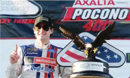  ??  ?? LONG POND: Ryan Blaney, driver of the #21 Motorcraft/Quick Lane Tire & Auto Center Ford, poses with the trophy in Victory Lane after winning the Monster Energy NASCAR Cup Series Axalta presents the Pocono 400 at Pocono Raceway on Sunday in Long Pond,...