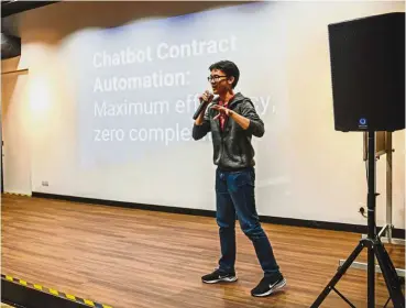  ?? — Photos: Marque Tan ?? Choo pitching his team’s idea – contract automation chatbot called askLaw – which won the top prize at the hackathon.