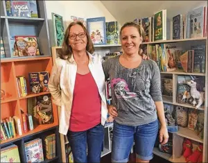  ?? KEVIN D. THOMPSON / THE PALM BEACH POST ?? Claire Ayraud (left) and her daughter, Tamara, at Book Cellar. The contest “will help with literacy and the knowledge of books and writing,” Ayraud said.