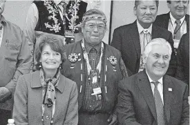  ?? [AP PHOTO] ?? U.S. Secretary of State Rex Tillerson, seated right, and U.S. Sen. Lisa Murkowski, seated left, pose with Nulato Chief Mickey Stickman at an Arctic Council event in Fairbanks, Alaska. High-level officials from the world’s eight Arctic nations,...