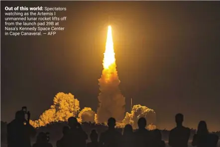  ?? — AFP ?? Out of this world: Spectators watching as the Artemis I unmanned lunar rocket lifts off from the launch pad 39B at Nasa’s Kennedy Space Center in Cape Canaveral.