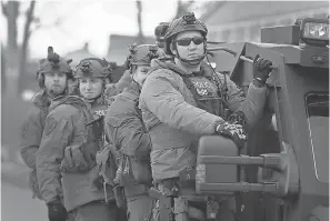  ?? SCOTT OLSON/GETTY IMAGES ?? Police secure the area following the shootings Friday at the Henry Pratt Co. plant in Aurora, Illinois. Five employees were killed and six officers were injured, including five shot during the gunbattle at the plant.