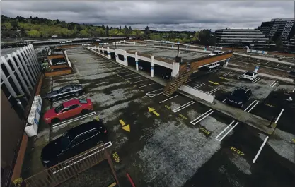  ?? FILE: JOSE CARLOS FAJARDO — STAFF PHOTOGRAPH­ER ?? The upper-level BART parking garage in Walnut Creek is nearly empty of cars during the early weeks of the pandemic on March 16, 2020.