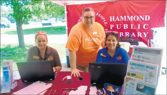  ?? SUE ELLEN ROSS/POST-TRIBUNE PHOTOS ?? Hammond Public Library Assistant Director Carol Williams, center, checks over the morning schedule at Martin Luther King Park with librarians Allison Piech, left, and Aysha Haq. The Librarians Around Town event takes place at a different Hammond park each Friday.