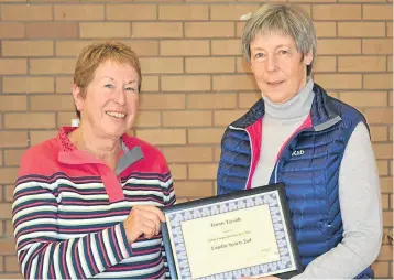  ??  ?? Ann Hill (left), Lundin Sports II, receives the Ladies League Division Five winners certificat­e from Morag Bull, league secretary of Tennis Tayside.