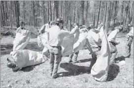  ??  ?? In this April 12, 2012, photo, Granite Mountain Hotshots crew members train on setting up emergency fire shelters outside Prescott, Ariz. On Sunday, 19 members of the Prescott-based crew were killed in the deadliest wildfire involving firefighte­rs in...