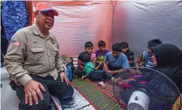  ?? ?? MEOR Ismail menyantuni mangsa banjir ketika melawat Pusat Pemindahan Sementara (PPS) Sekolah Menengah Kebangsaan Geting.