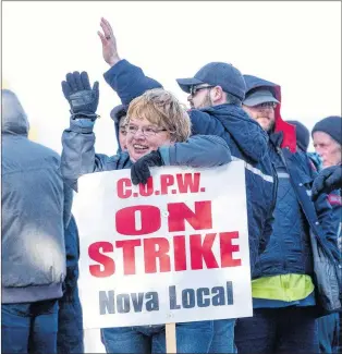  ?? CP PHOTO ?? Canadian Union of Postal Workers (CUPW) members stand on picket line in front of the Canada Post regional sorting headquarte­rs in Halifax Monday after a call for a series of rotating 24-hour strikes.