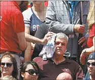  ?? Michael Dwyer / Associated Press ?? Fenway Park personnel attend to a fan who was hit by a broken bat during a 2016 game in Boston. Too many fans have been left bloody and maimed by projectile­s hurtling into the stands.