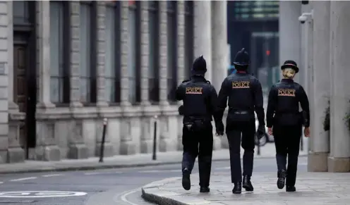  ??  ?? Police officers patrol the near-deserted streets of the City of London yesterday during the Covid-19 pandemic.