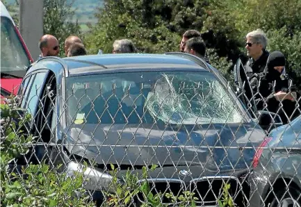  ?? PHOTO: REUTERS ?? French police surround a car dotted with bullet holes where the man suspected of ramming a car into soldiers in Paris was shot and arrested.