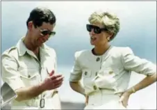  ??  ?? In this April 23, 1991, photo, Britain’s Prince Charles and Princess Diana laugh together during their visit to an iron ore mine near Carajas, Brazil.