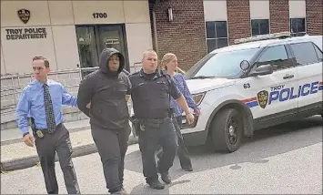  ?? Troy Police Department ?? Law enforcemen­t officials say some of the Capital Region’s recent homicides may be the result of two rival gangs renewing street violence. Here, Jahquay Brown is taken to his arraignmen­t in connection with the killing of 11-year-old Ayshawn Davis in Troy.