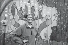  ?? KATHY KMONICEK/AP PHOTO ?? Kailani Taylor-Cribb stands in front of mural at a community garden in Asheville, N.C.