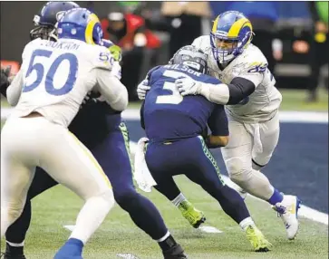  ?? Scott Eklund Associated Press ?? RAMS DEFENSIVE TACKLE Aaron Donald, right, had 131⁄2 sacks in the regular season, second in the NFL.